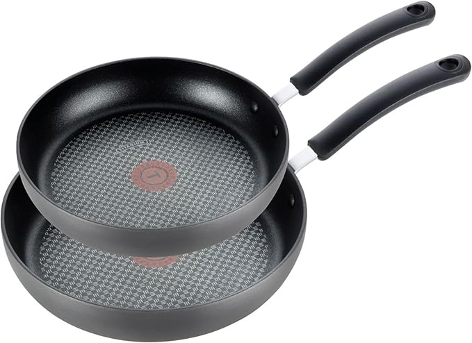 A set of two T-fal non-stick skillets with heat indicators in the center, featuring a durable non-stick surface and comfortable handles for easy cooking